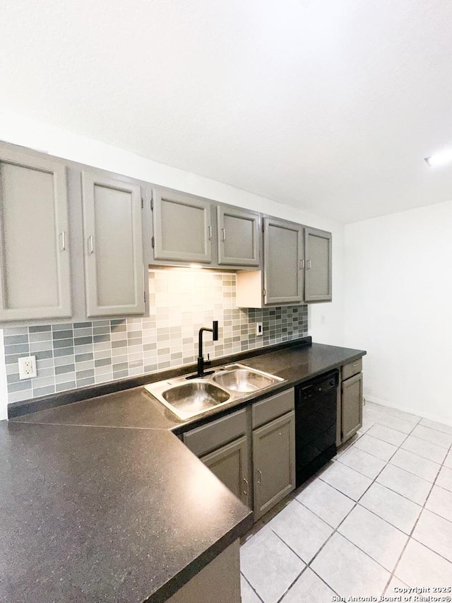 kitchen featuring gray cabinets, tasteful backsplash, black dishwasher, and sink