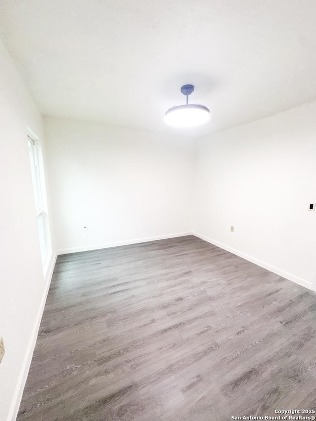 empty room featuring dark wood-type flooring