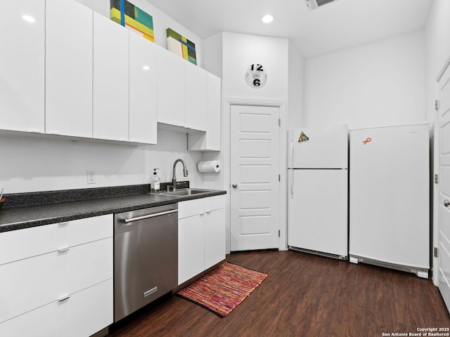 kitchen featuring sink, white cabinetry, dark hardwood / wood-style floors, white refrigerator, and stainless steel dishwasher