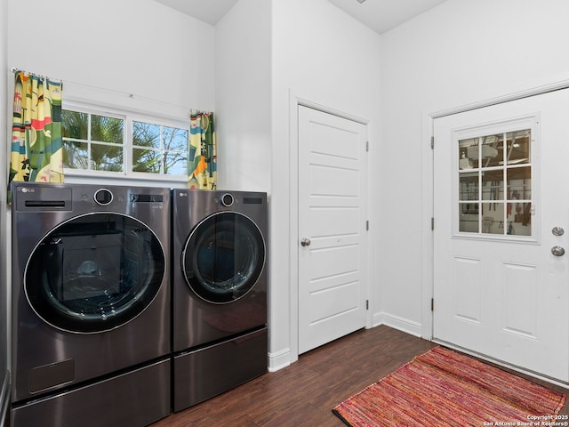 washroom featuring dark hardwood / wood-style floors and washing machine and dryer