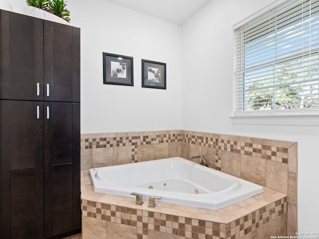 bathroom featuring a relaxing tiled tub