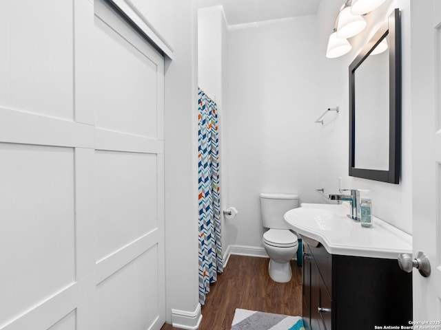 bathroom featuring vanity, hardwood / wood-style floors, and toilet