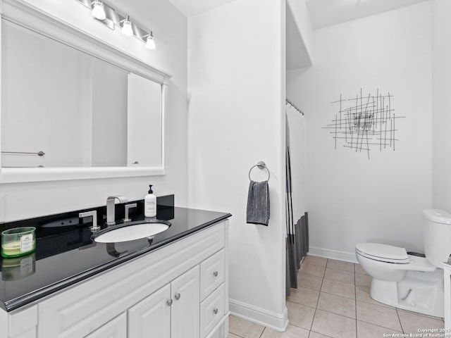 bathroom featuring vanity, toilet, and tile patterned flooring