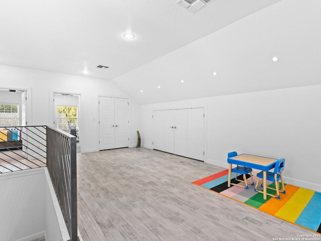 game room with lofted ceiling and light hardwood / wood-style floors