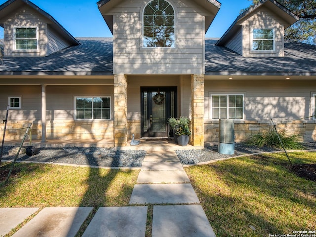 entrance to property featuring a lawn