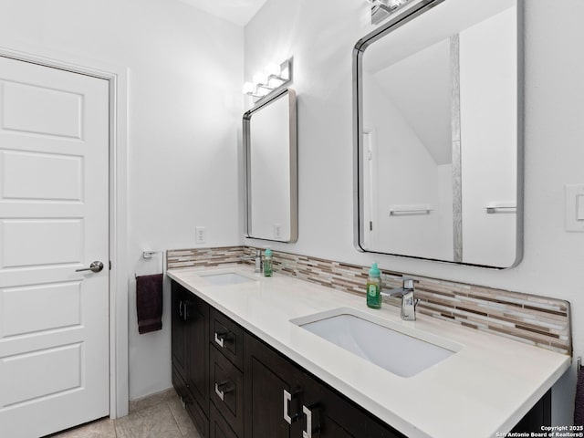 bathroom with tasteful backsplash and vanity