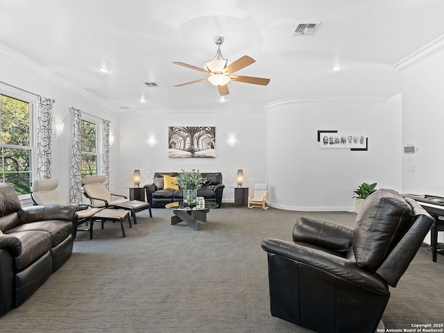 carpeted living room with crown molding and ceiling fan