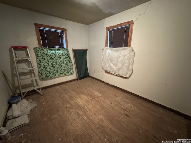 empty room with hardwood / wood-style floors