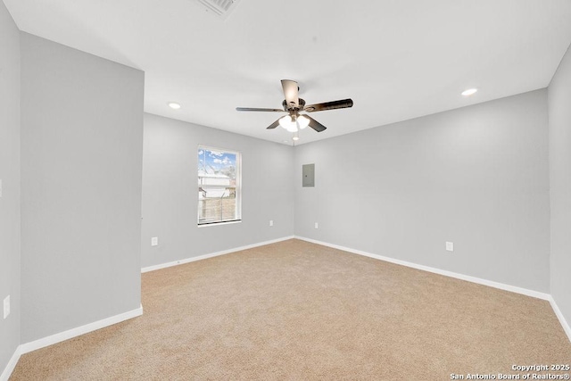 carpeted spare room featuring electric panel and ceiling fan