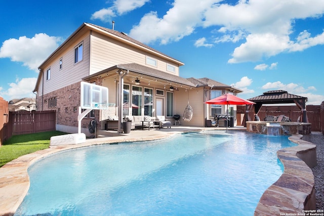 back of house featuring a gazebo, outdoor lounge area, a pool with hot tub, ceiling fan, and a patio