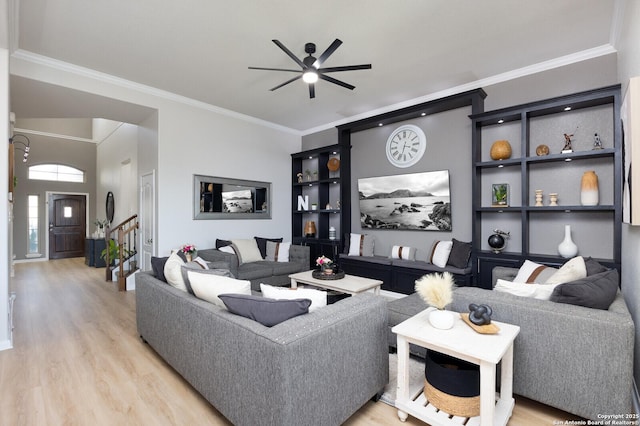 living room featuring ceiling fan, ornamental molding, and light hardwood / wood-style flooring