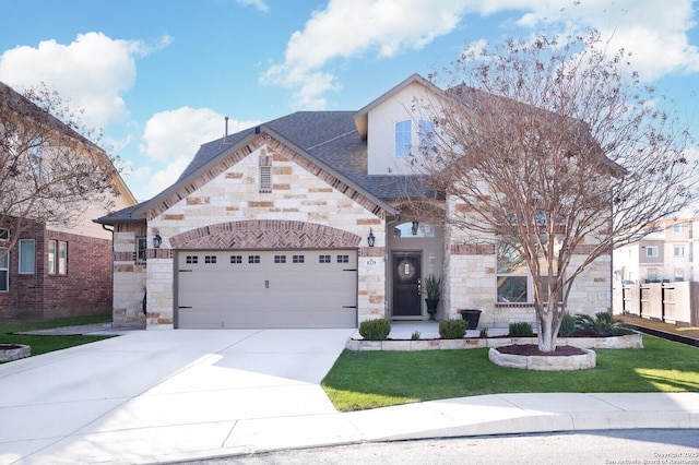 view of front of home featuring a garage and a front yard