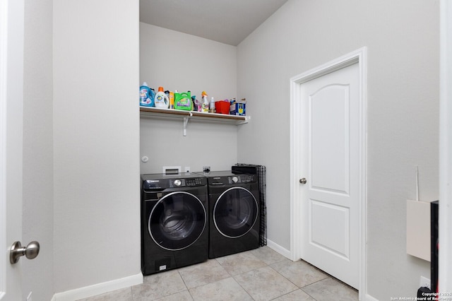 laundry room with light tile patterned floors and washer and clothes dryer