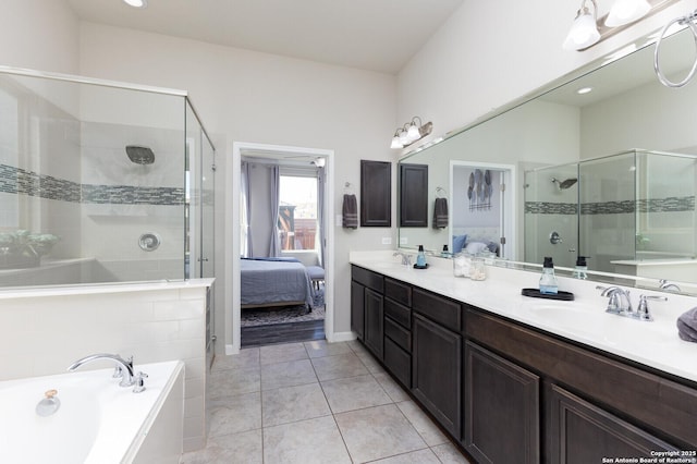 bathroom with tile patterned floors, independent shower and bath, and vanity