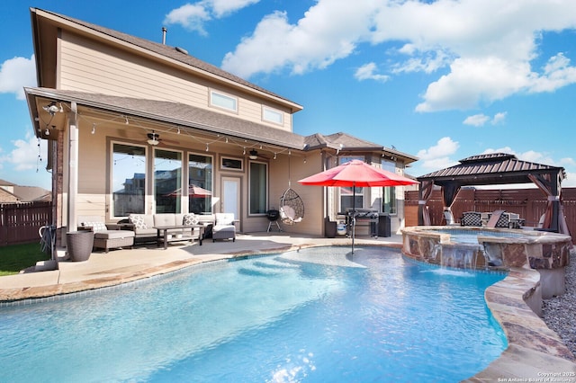 rear view of house with a gazebo, ceiling fan, a swimming pool with hot tub, an outdoor hangout area, and a patio