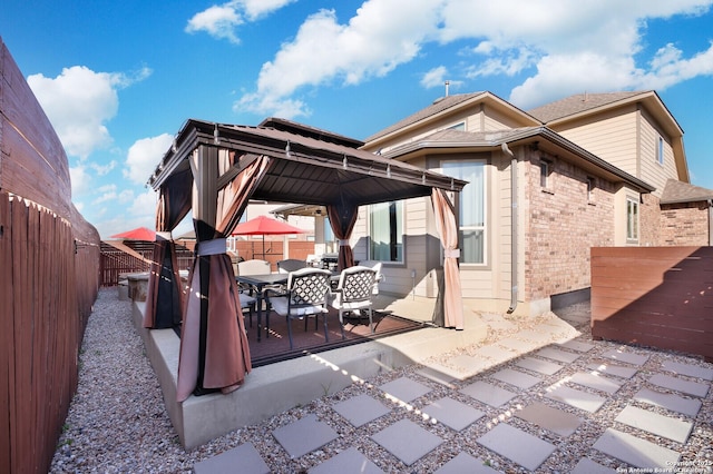 back of house with a gazebo and a patio area