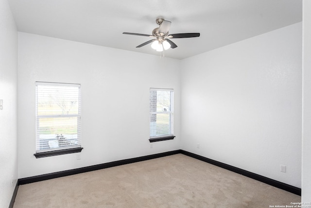 unfurnished room with ceiling fan and light colored carpet