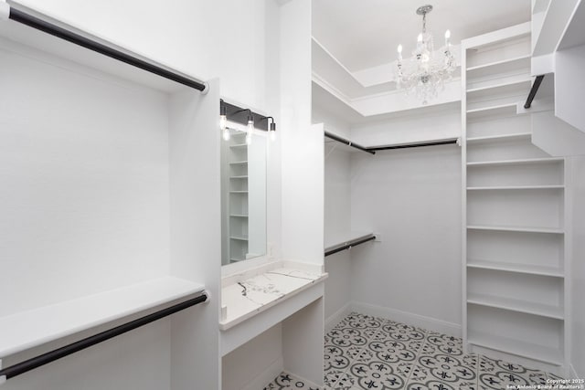 spacious closet featuring an inviting chandelier