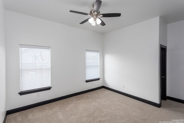 unfurnished room featuring light carpet and ceiling fan