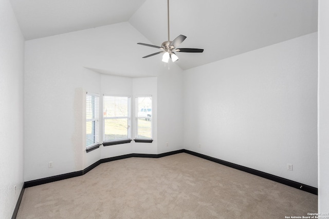 carpeted spare room featuring lofted ceiling and ceiling fan