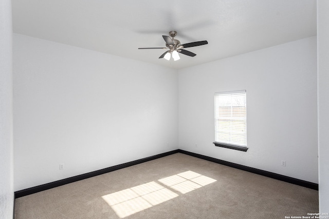 carpeted spare room with ceiling fan