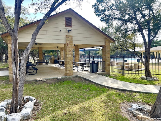 view of community featuring a yard, a gazebo, and a patio area