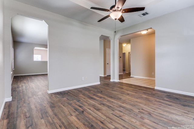 empty room featuring ceiling fan and dark wood-type flooring