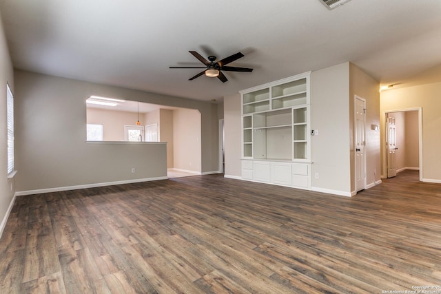 unfurnished living room with ceiling fan, built in features, and dark hardwood / wood-style floors