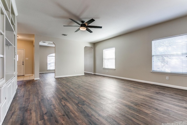 unfurnished room with ceiling fan and dark wood-type flooring