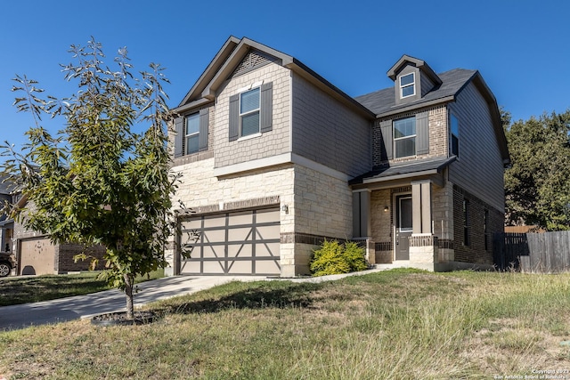 craftsman-style house with a front yard and a garage