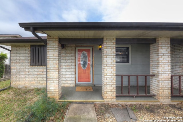 view of exterior entry featuring a porch