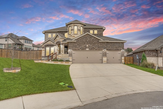 view of front of house featuring a garage and a yard