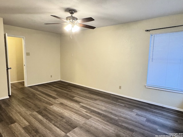 spare room featuring dark hardwood / wood-style flooring and ceiling fan