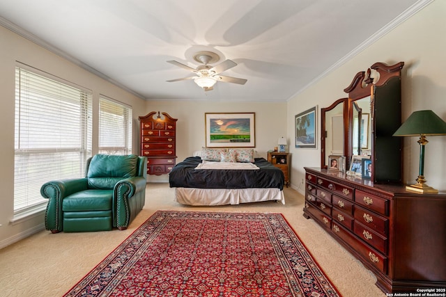 carpeted bedroom with ornamental molding and ceiling fan