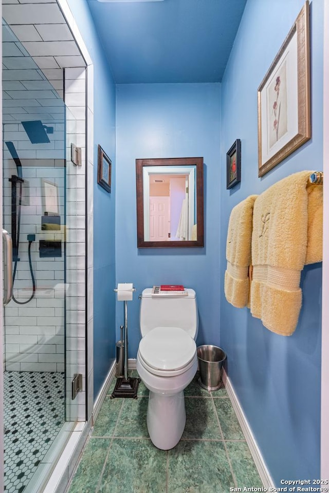 bathroom featuring toilet, tile patterned flooring, and an enclosed shower