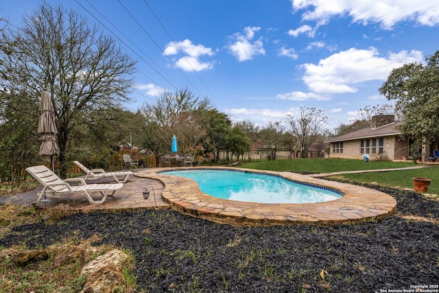 view of swimming pool with a lawn and a patio area