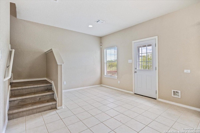 foyer entrance with light tile patterned flooring