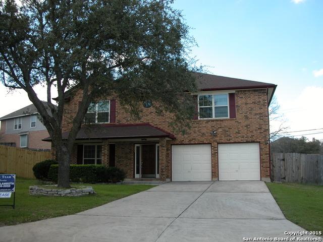 25002 Silverstone, San Antonio, TX 78258 - traditional-style home with driveway, a garage, and brick siding