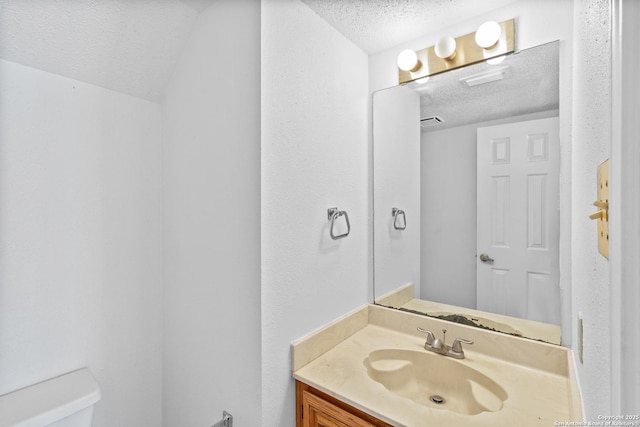 25002 Silverstone, San Antonio, TX 78258 - bathroom with a textured ceiling and vanity