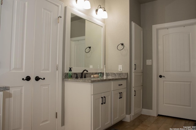 bathroom featuring hardwood / wood-style flooring and vanity