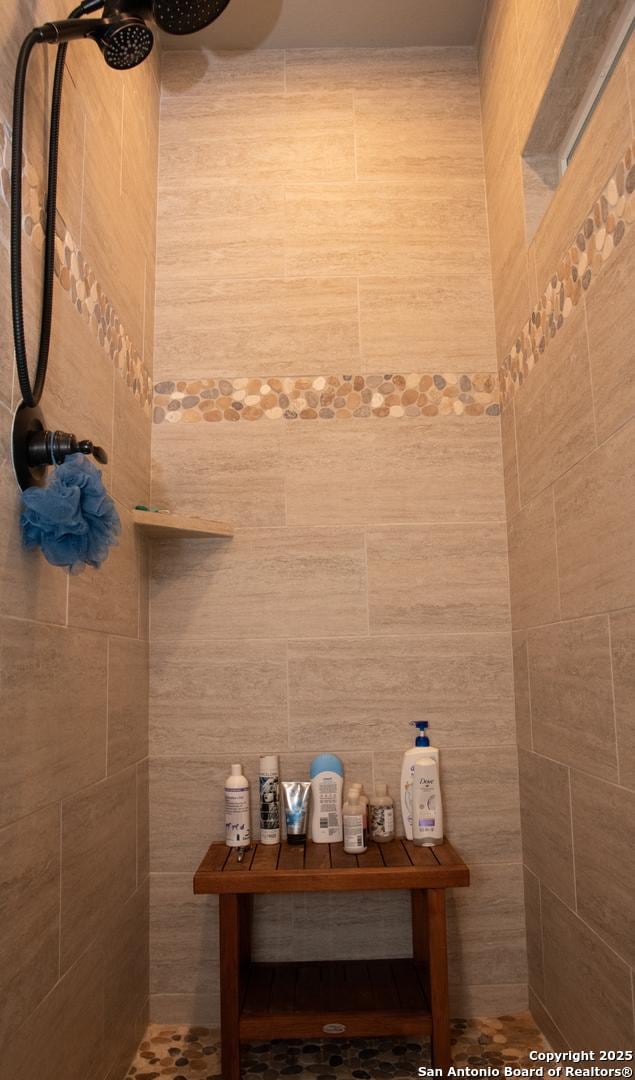 bathroom with tiled shower