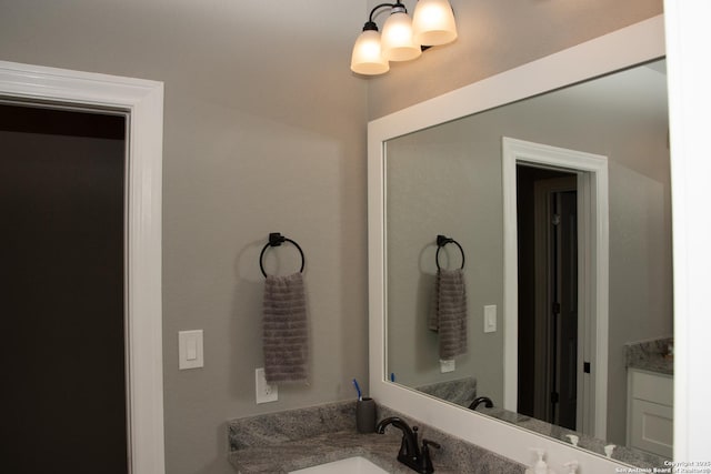 bathroom featuring vanity and a notable chandelier