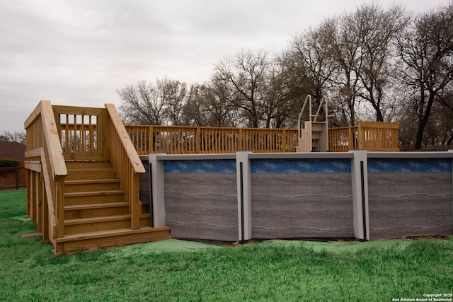 view of pool featuring a lawn