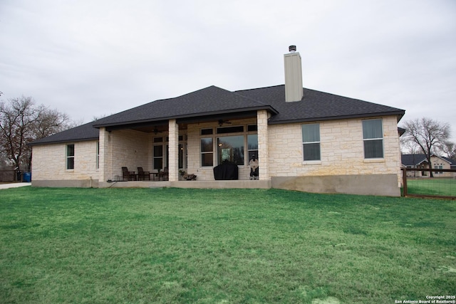 back of house featuring a yard, a patio, and ceiling fan