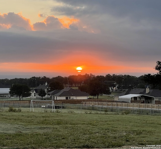 yard at dusk with a rural view