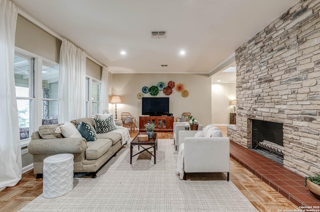 living room featuring parquet floors, crown molding, and a fireplace