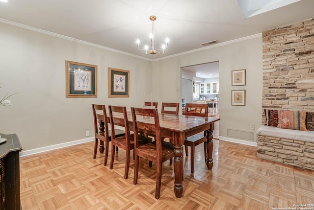 dining room with light parquet floors, ornamental molding, and a notable chandelier