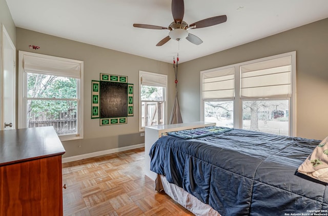 bedroom with light parquet floors and ceiling fan