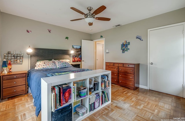 bedroom with ceiling fan and light parquet floors