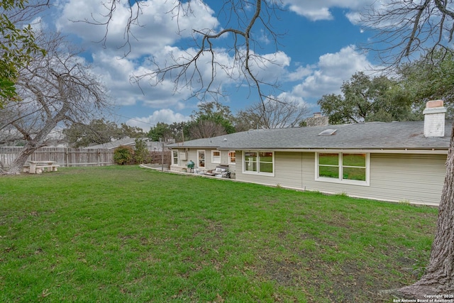 rear view of property with a patio area and a lawn